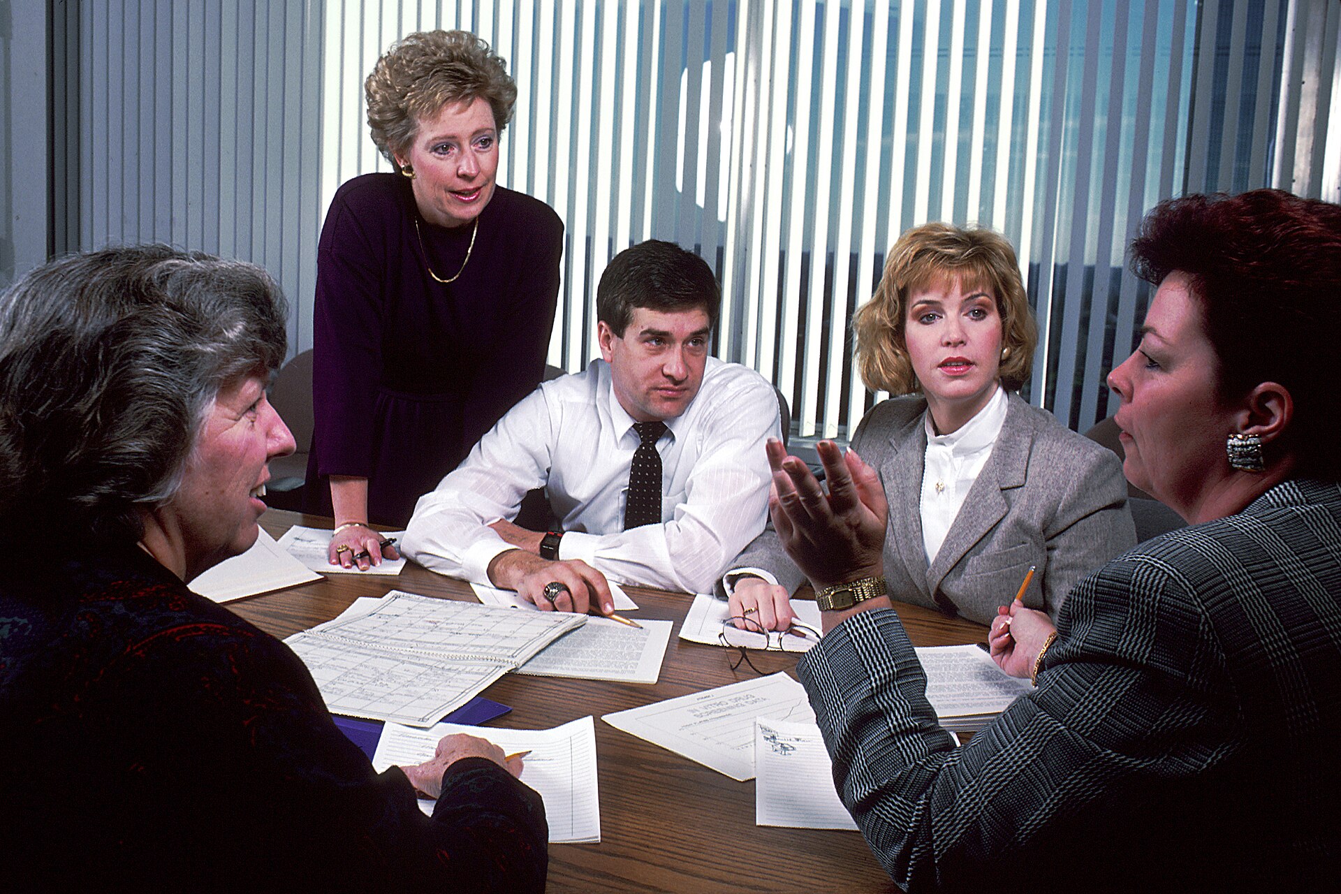 Colleagues talking around a meeting table