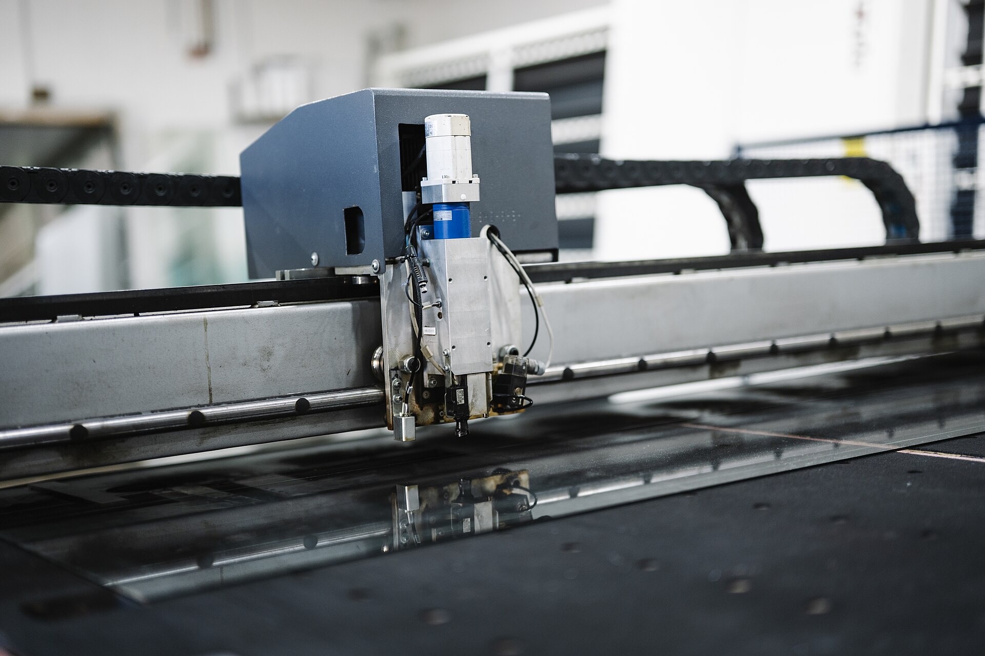 A machine cutting material on a workshop production line