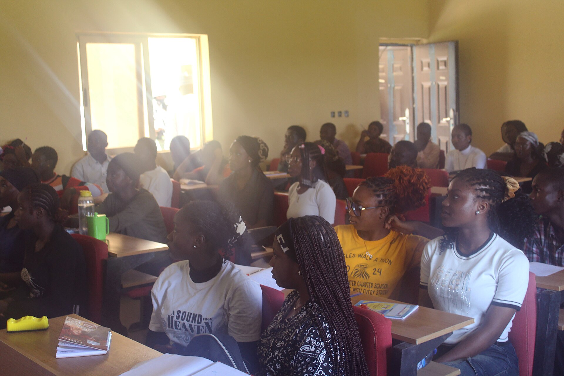 Adult students seated in a lecture room listening to a trainer